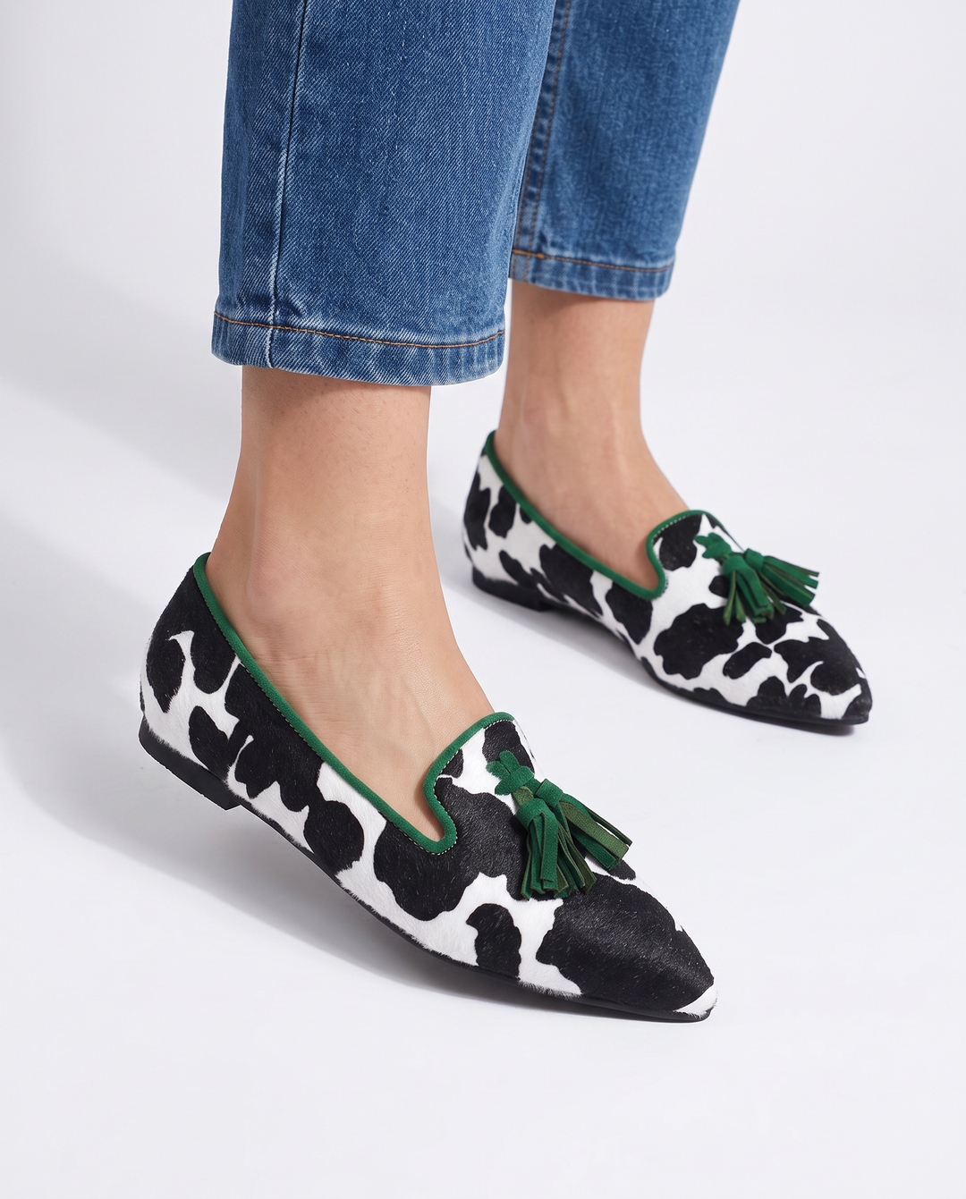 Ginevra Moccasin | Black and White Cow Print, Green Tassels